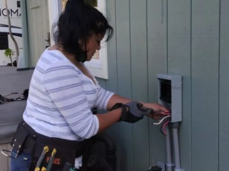 Licensed electrician wiring an exterior subpanel in Bellbrook